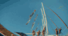 a man and a woman are hanging from a sailboat in the water .