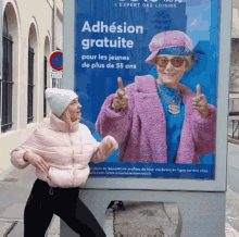 a woman is standing in front of a billboard that says adhésion gratuite