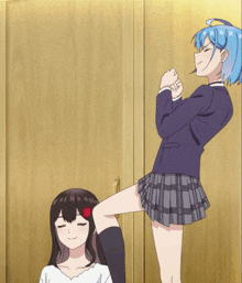 a girl with blue hair is kicking another girl in the face