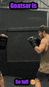 a man wearing boxing gloves with the words goatsar is so tuff on the bottom