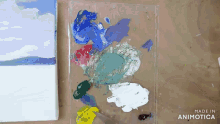 a palette with a painting in the background and the words made in animotica on the bottom