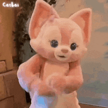 a stuffed animal is being held in someone 's arms .