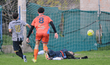a soccer player with the number 8 on his jersey kicks the ball