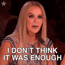 a woman speaking into a microphone with the words " i don 't think it was enough " below her