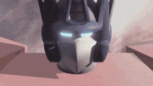 a close up of a robot head with blue lights on