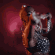 a woman in a silver dress is holding a rope in her hand