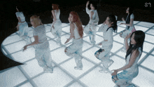 a group of women are dancing in a circle with the letters s on the bottom right