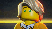 a close up of a lego figure with a sad look on his face .