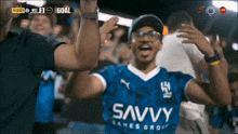a man wearing a blue shirt with the word savvy on it