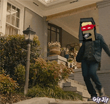 a man wearing a ninja turtle mask is walking down the stairs