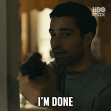 a man is holding a gun and saying " i 'm done "