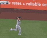 a new york yankees baseball player is running towards a base