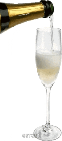 a bottle of champagne is being poured into a glass of champagne .