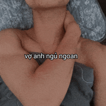 a close up of a person 's neck with the words " vợ anh ngủ ngoan " below it