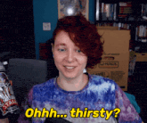 a woman with red hair is holding a can of root beer and says ohh thirsty