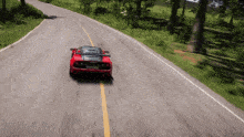a red sports car is driving down a curvy road with a license plate that says jcw 88