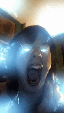 a close up of a woman with her mouth open