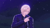 a man in a suit is holding a microphone in his hand