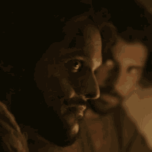 a close up of a man 's face with a beard