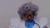 a woman wearing a wig and glasses is holding a pair of glasses