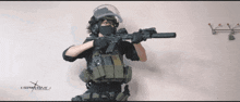 a person holding a rifle with a website written on the bottom right