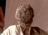 a close up of a person 's head with a crown on