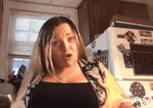 a woman is standing in front of a refrigerator with a calendar on it that says april