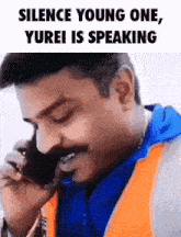 a man is talking on a cell phone with the words `` silence young one , yurei is speaking '' written above him .
