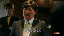 a man in a suit and tie is saying " you jangan main-main saya punya feeling ah "