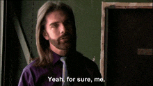 a man with long hair and a beard is saying " yeah for sure me "