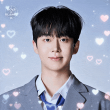 a boy in a suit and tie is surrounded by hearts and the words boys planet