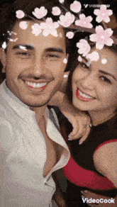 a man and woman are posing for a picture with flowers on their faces and the words videocook below them