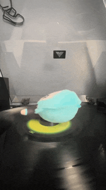 a record player with a blue stuffed animal on it