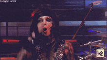a gif of a man playing a keyboard with a fuel logo on the bottom right