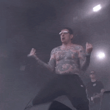 a shirtless man with a tattoo on his chest that says muerto
