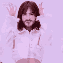 a man with a beard is wearing a white crop top