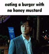 a man in a suit is eating a burger without honey mustard