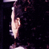 a close up of a woman 's face with a bow in her hair