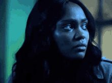 a close up of a woman 's face with a serious look on her face