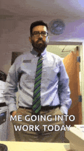 a man in a shirt and tie is standing in front of a clock and says me going into work today .