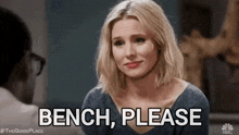 a woman is sitting in front of a man and says bench please .