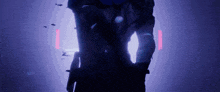 a person is standing in a dark room with a purple light behind them .