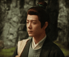 a man with a bun on his head looks to the side