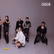a group of people dancing in front of a studio choom logo