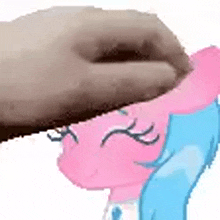 a person is touching a pink and blue cartoon character 's head .