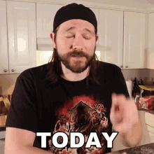 a man with long hair and a beard wears a black shirt that says today