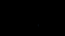 a silhouette of a woman standing in front of a window looking out to the ocean