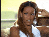 a woman sitting on a couch making a face
