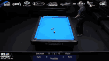 a pool table with a blue cloth and a man playing pool