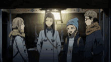 a group of people standing next to each other with one wearing a blue beanie